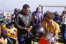 The leader of the Black Knights, Smoke (LAURENCE FISHBURNE, left) takes a moment between races with Soul Train (ORLANDO JONES) another member of his club.