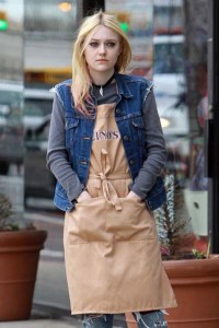 **EXCLUSIVE** Dakota Fanning dresses up as a bagel shop employee to film a scene for 'Every Secret Thing' in New York
